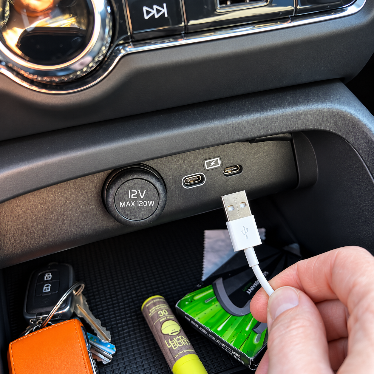 Vehicle USB ports and iPhone charging cable close-up