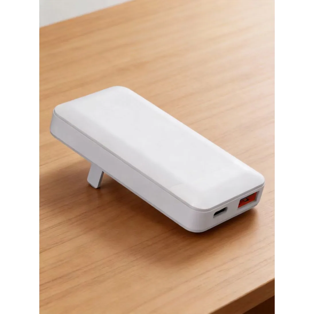 SUNDA HC032 65W GaN charger in white on a wooden desk with the twin USB-C ports facing forward