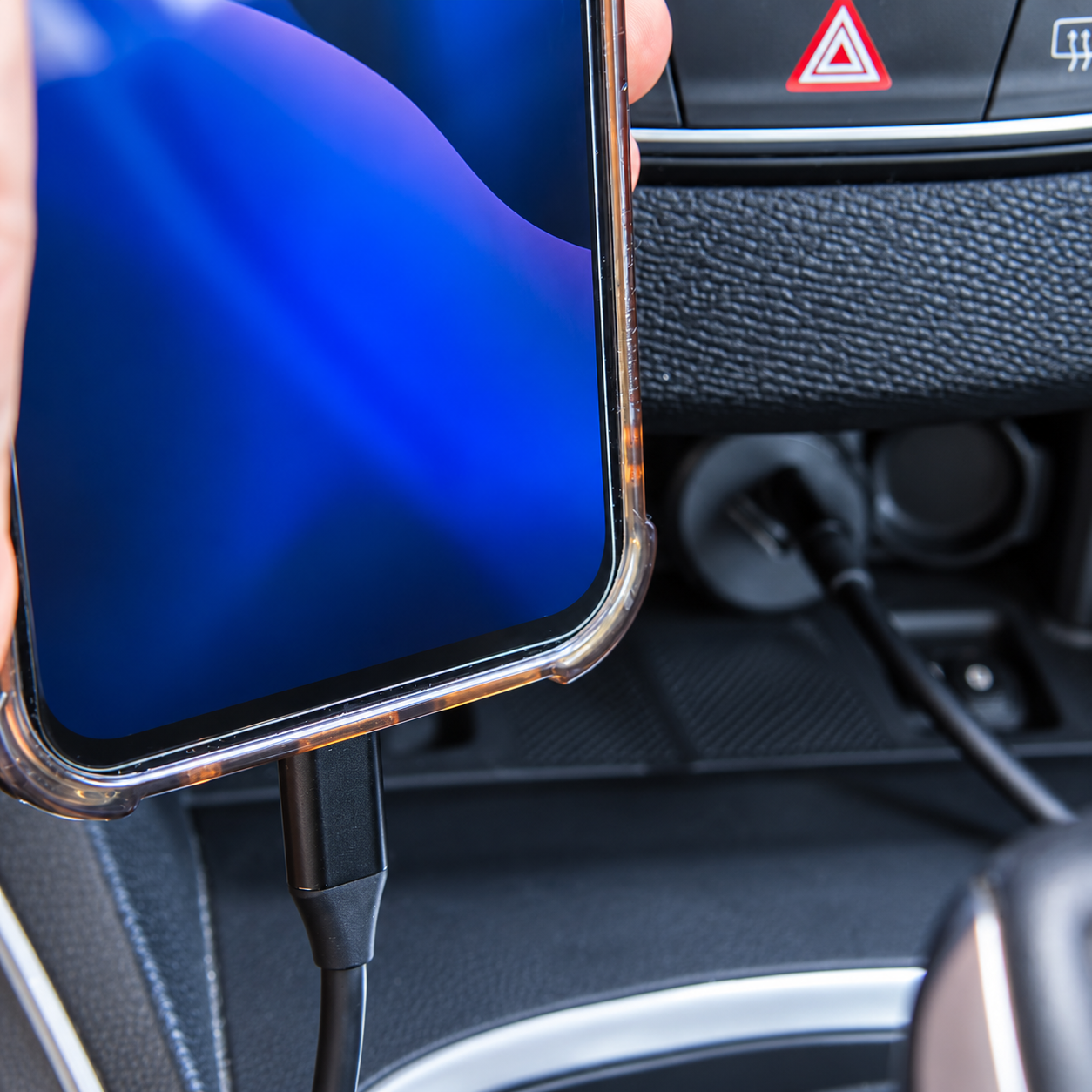 Phone charging cable connected inside a car