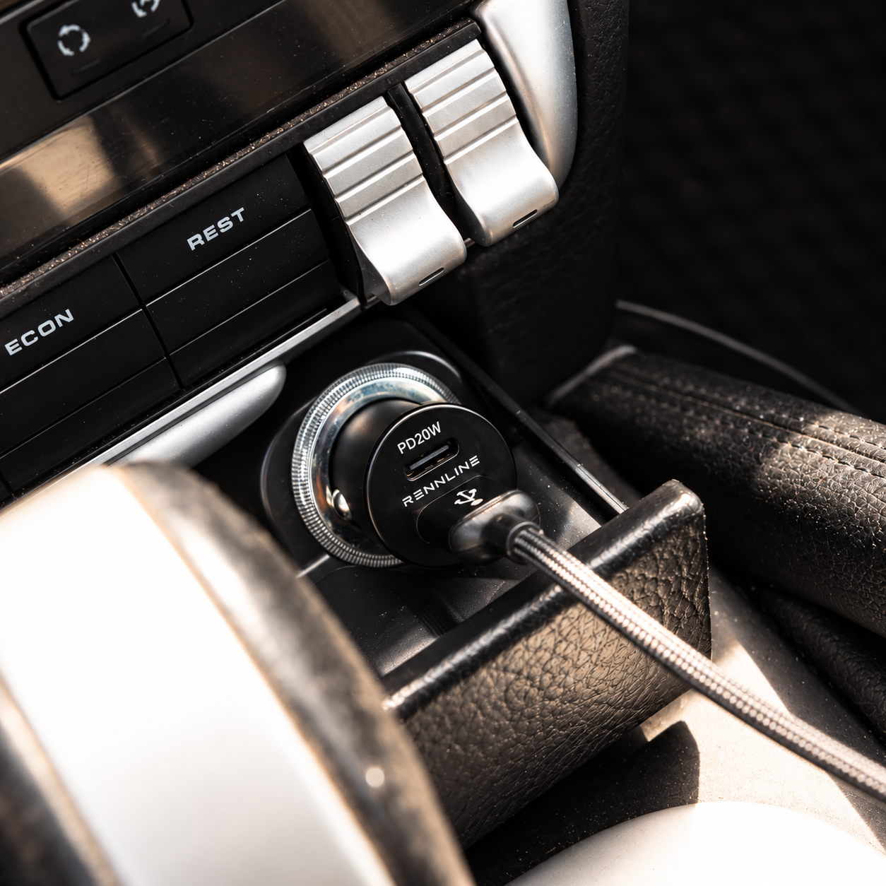 Plug-in USB-C car charger connected inside a vehicle cigarette lighter socket