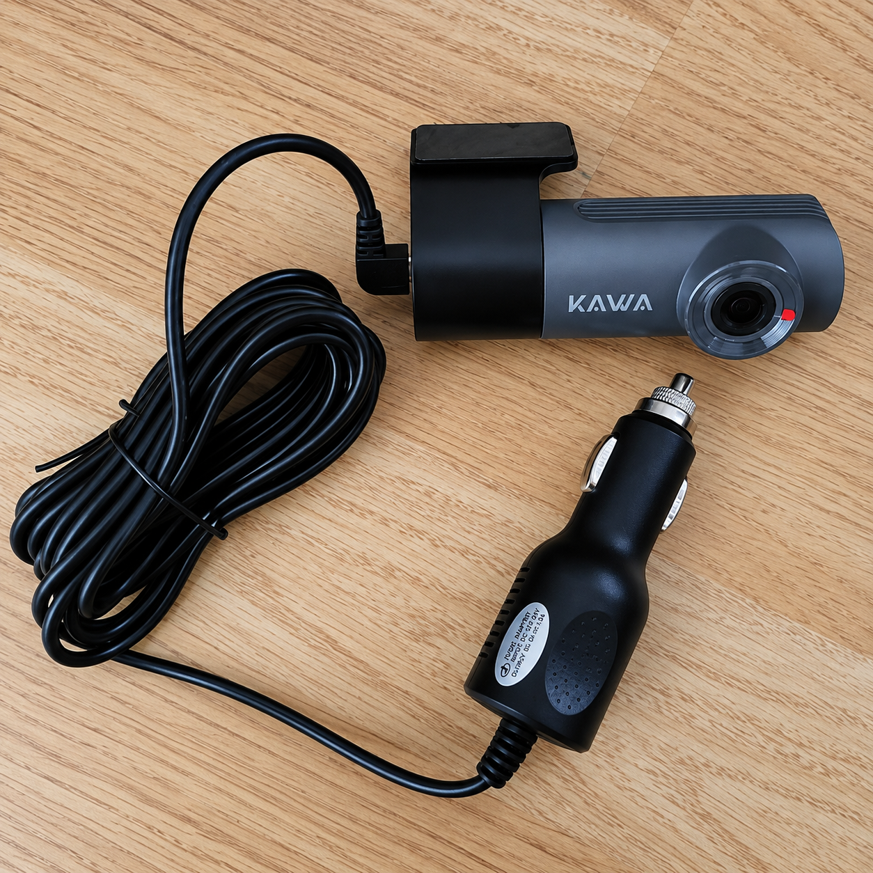 USB car charger and dash camera power adapter on wooden surface